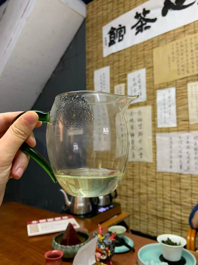 Clear golden green tea soup of Anxi Tieguanyin oolong tea showing its fresh color and brightness