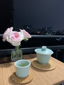 Wuyi Rock Oolong Tea: Origin & Brewing Guide enjoy wuyi rock oolong tea and admire flowers in balcony at evening