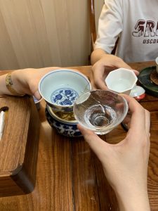 🍵 Why I Started Serenitea Tea House Friends sharing a tea moment and toasting with Chinese tea in a tea house